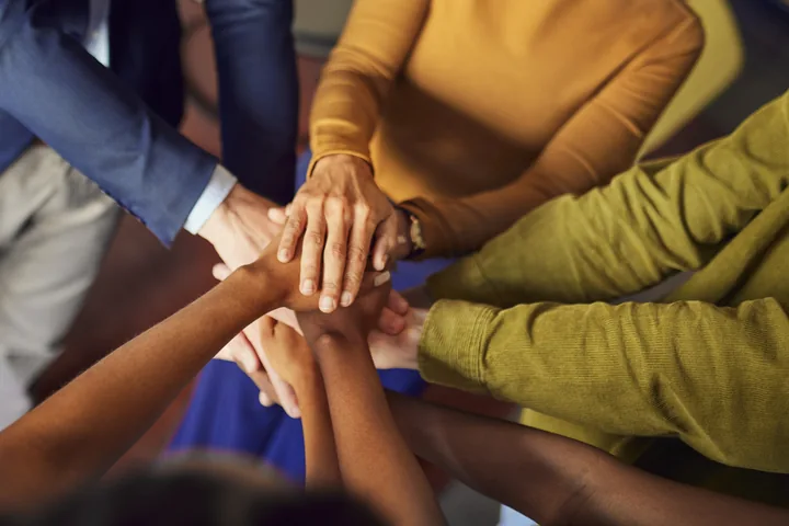 A circle of hands joined together